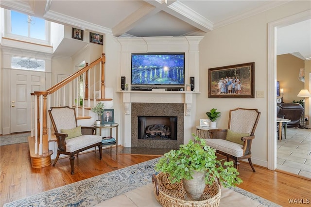 living area with coffered ceiling, stairway, ornamental molding, wood finished floors, and beamed ceiling