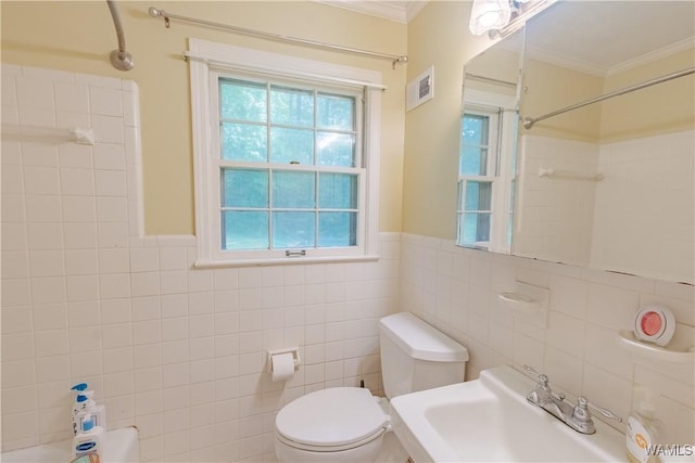 3709 Diamond Ln, Northport, AL 35473 - full bath featuring crown molding, toilet, a sink, tile walls, and shower / bathtub combination