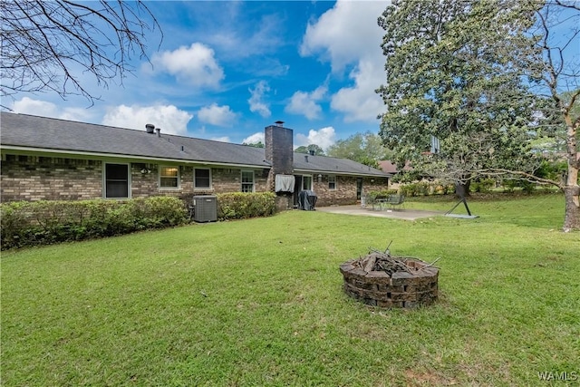 3709 Diamond Ln, Northport, AL 35473 - rear view of property with an outdoor fire pit, a patio area, central air condition unit, a chimney, and a lawn