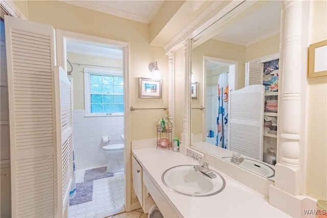 3709 Diamond Ln, Northport, AL 35473 - full bath featuring crown molding, vanity, toilet, tile walls, and tile patterned flooring