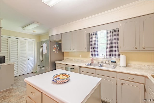 3709 Diamond Ln, Northport, AL 35473 - kitchen with a sink, appliances with stainless steel finishes, light countertops, stone finish floors, and ornamental molding