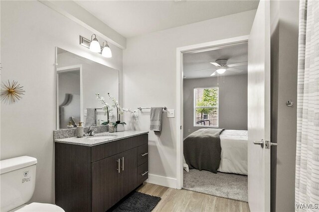 680 6th Ave NE Unit 3401, Tuscaloosa, AL 35404 - bathroom featuring vanity, ceiling fan, wood-type flooring, and toilet