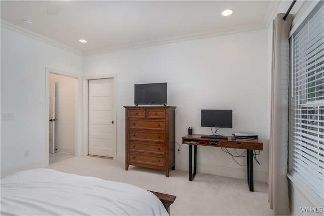 carpeted bedroom featuring ceiling fan and crown molding