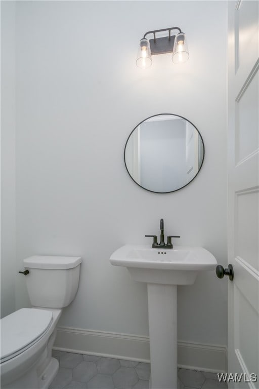 bathroom featuring tile patterned floors and toilet