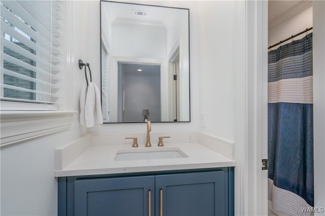 bathroom featuring vanity and crown molding