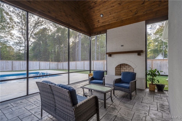 sunroom / solarium featuring an outdoor brick fireplace, wood ceiling, and vaulted ceiling