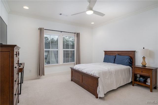 carpeted bedroom featuring ceiling fan and ornamental molding