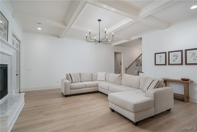 living room featuring beamed ceiling, light hardwood / wood-style floors, and coffered ceiling