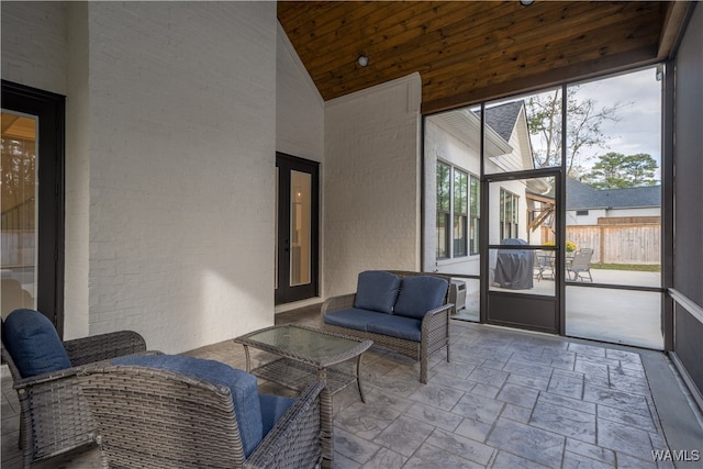 sunroom featuring wooden ceiling and vaulted ceiling