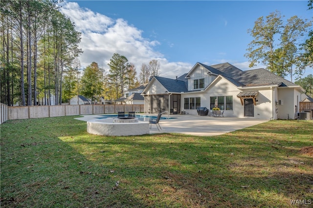 rear view of house featuring a sunroom, a patio area, a yard, and central air condition unit