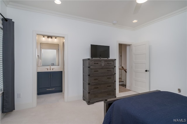 carpeted bedroom with ensuite bathroom, ceiling fan, crown molding, and sink