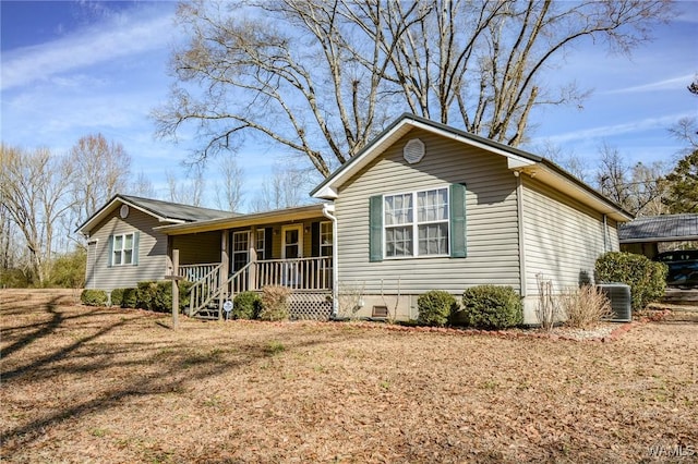 single story home with a porch, a front yard, and central AC unit