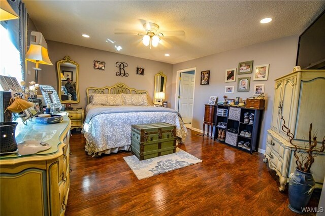 bedroom featuring ceiling fan, dark hardwood / wood-style floors, and a textured ceiling