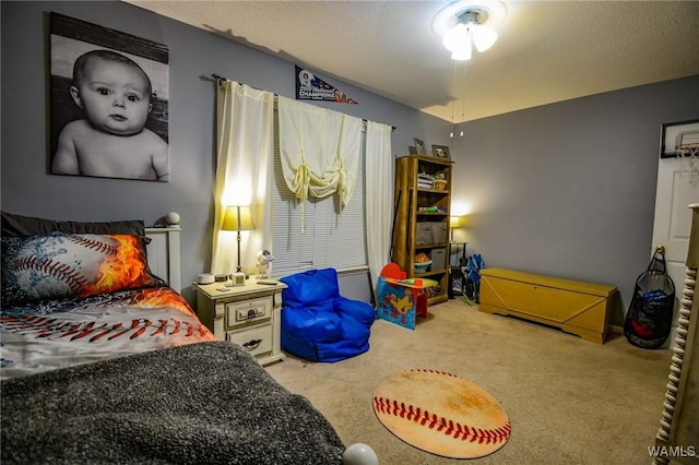 bedroom with carpet floors and a textured ceiling