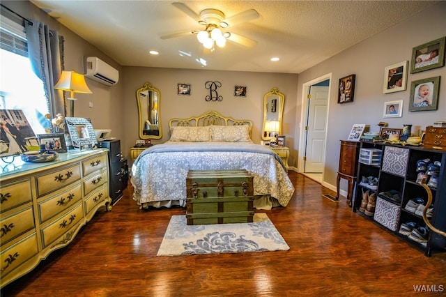 bedroom with dark hardwood / wood-style floors, a wall mounted air conditioner, a textured ceiling, and ceiling fan