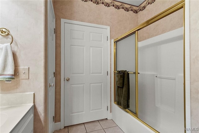 bathroom featuring vanity, combined bath / shower with glass door, and tile patterned floors