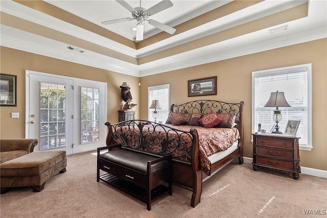 bedroom with access to outside, light colored carpet, visible vents, and multiple windows