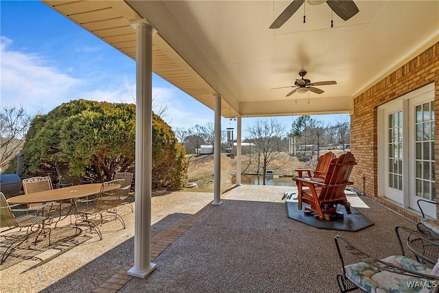 view of patio featuring outdoor dining area and a ceiling fan