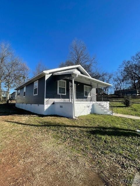 view of front of house featuring crawl space, covered porch, and a front lawn