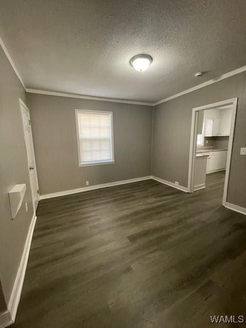 unfurnished bedroom with a textured ceiling, dark wood-style flooring, and crown molding