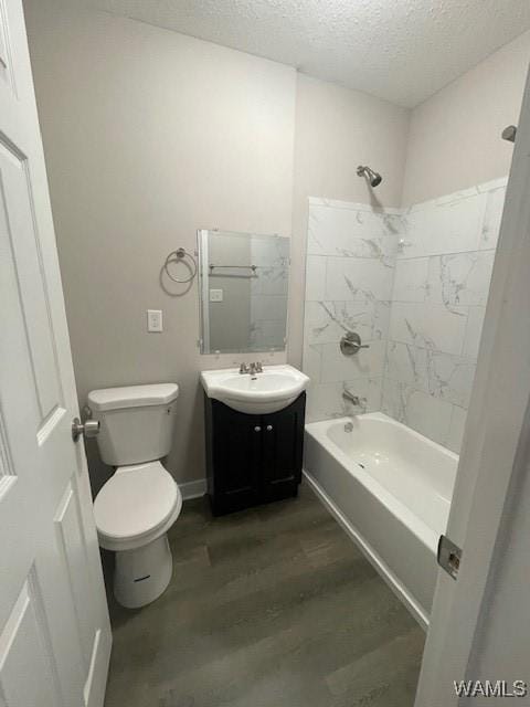 bathroom featuring shower / bath combination, toilet, wood finished floors, a textured ceiling, and vanity