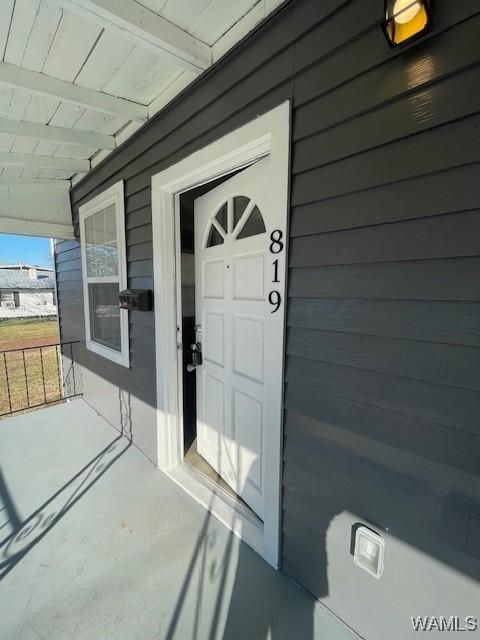 property entrance with covered porch