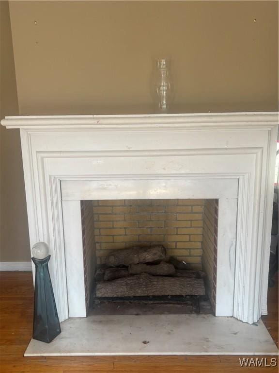 details with a fireplace and wood finished floors