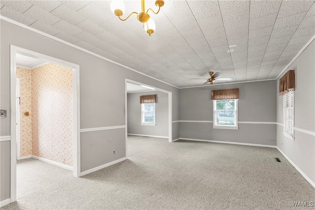 empty room with light carpet, crown molding, ceiling fan, and a healthy amount of sunlight