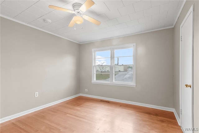 spare room featuring ceiling fan, light wood-type flooring, and crown molding