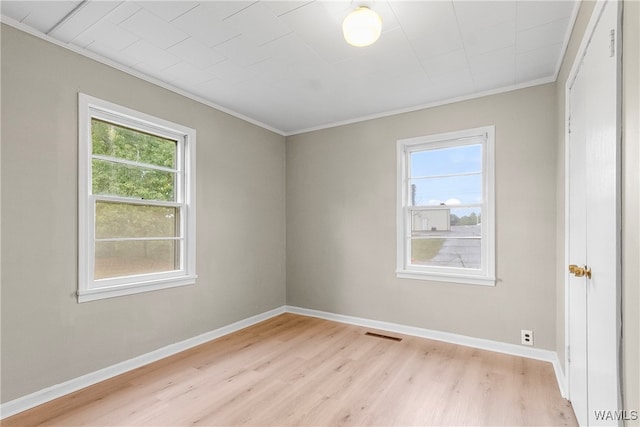 unfurnished room featuring light hardwood / wood-style flooring and ornamental molding