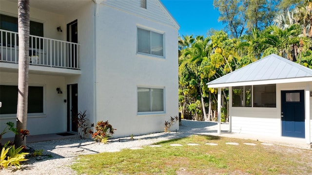 view of side of home featuring a balcony