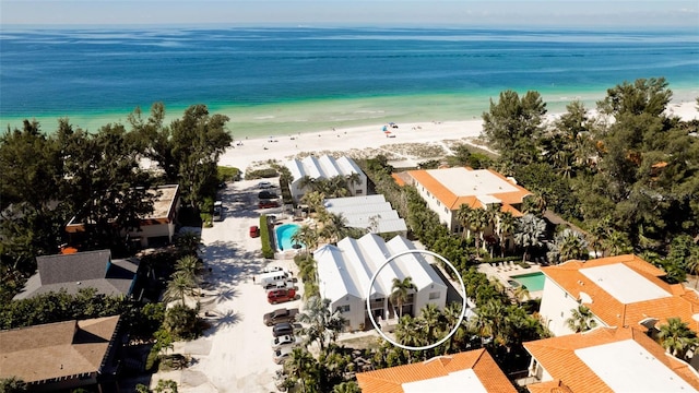 birds eye view of property featuring a water view and a view of the beach