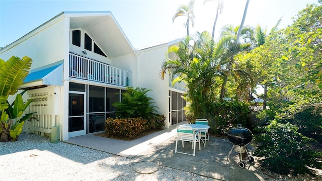 back of house with a balcony and a patio area