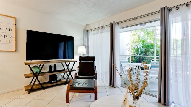 living area with light tile flooring and a textured ceiling