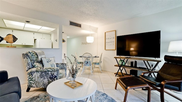 tiled living room featuring a textured ceiling