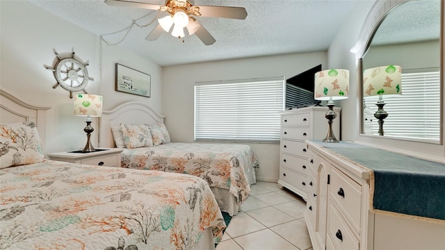 bedroom with light tile floors, a textured ceiling, multiple windows, and ceiling fan