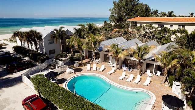 view of swimming pool featuring a patio area and a water view