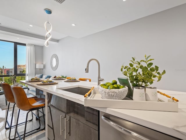 kitchen with dishwasher, decorative light fixtures, floor to ceiling windows, and sink