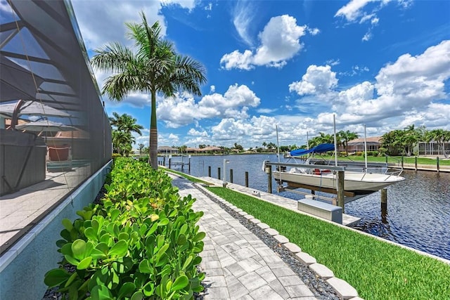 view of dock with glass enclosure and a water view