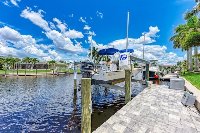 view of dock with a lanai and a water view