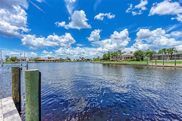 view of dock featuring a water view and glass enclosure