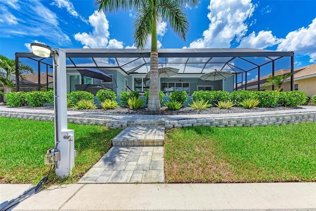 exterior space with a front yard and a lanai