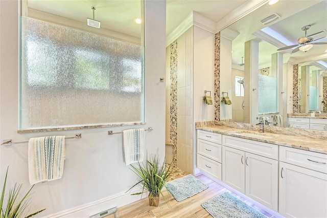 bathroom with oversized vanity, ceiling fan, and hardwood / wood-style flooring