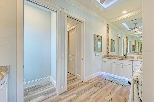 bathroom featuring vanity, crown molding, ceiling fan, and hardwood / wood-style floors