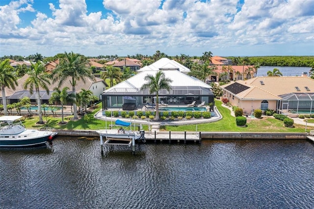 view of dock featuring a lawn, a water view, and a lanai