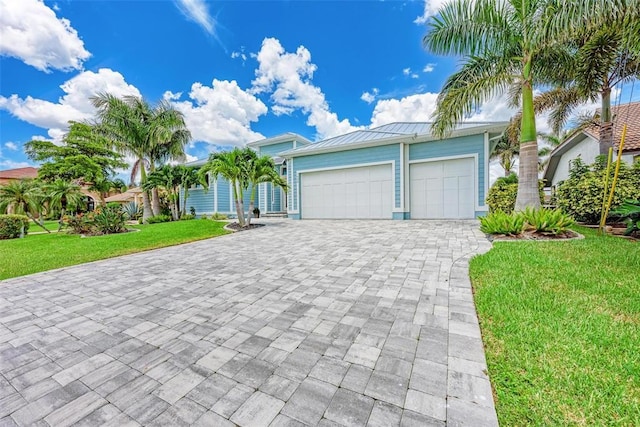 view of front of property with a front yard and a garage