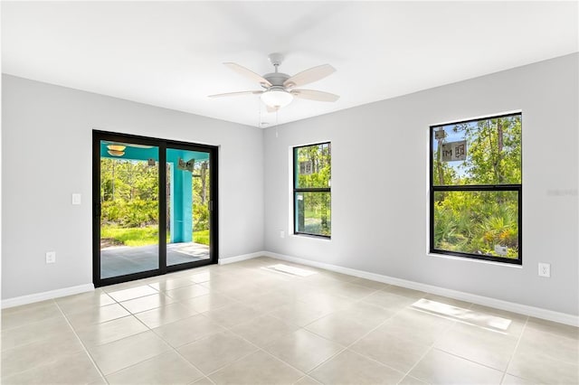 tiled spare room featuring ceiling fan