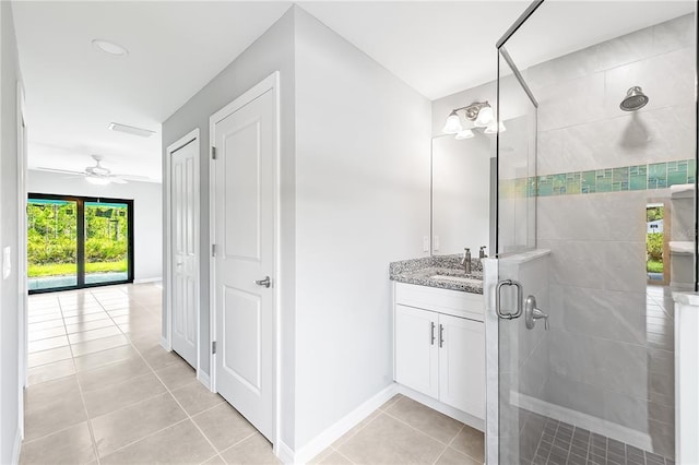 bathroom featuring a shower with shower door, tile floors, ceiling fan, and vanity