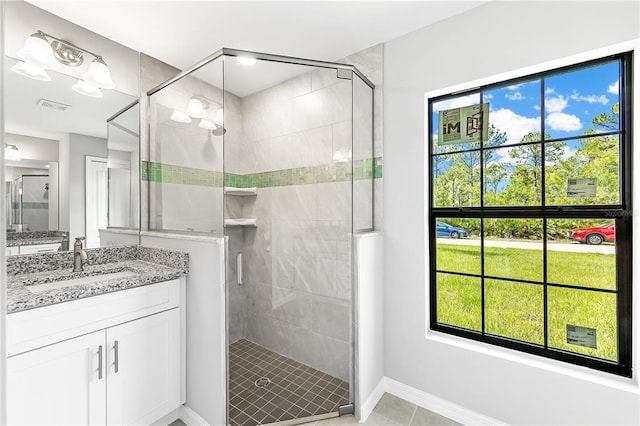 bathroom featuring an enclosed shower, tile flooring, and large vanity