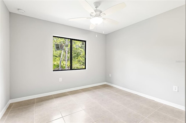 empty room with ceiling fan and light tile floors